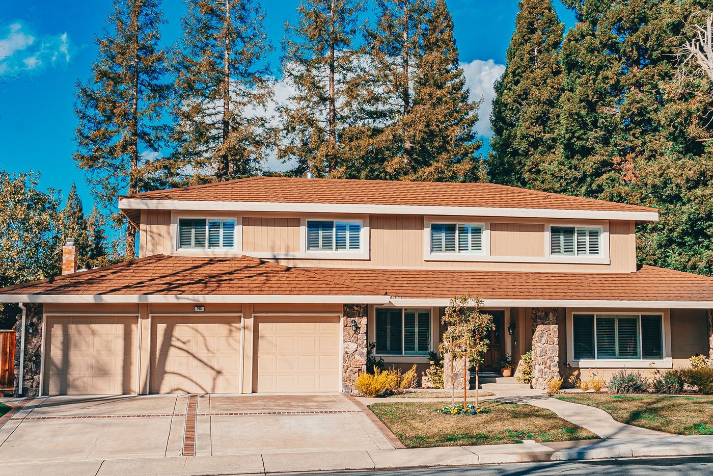 Two-story home with a garage and front garden