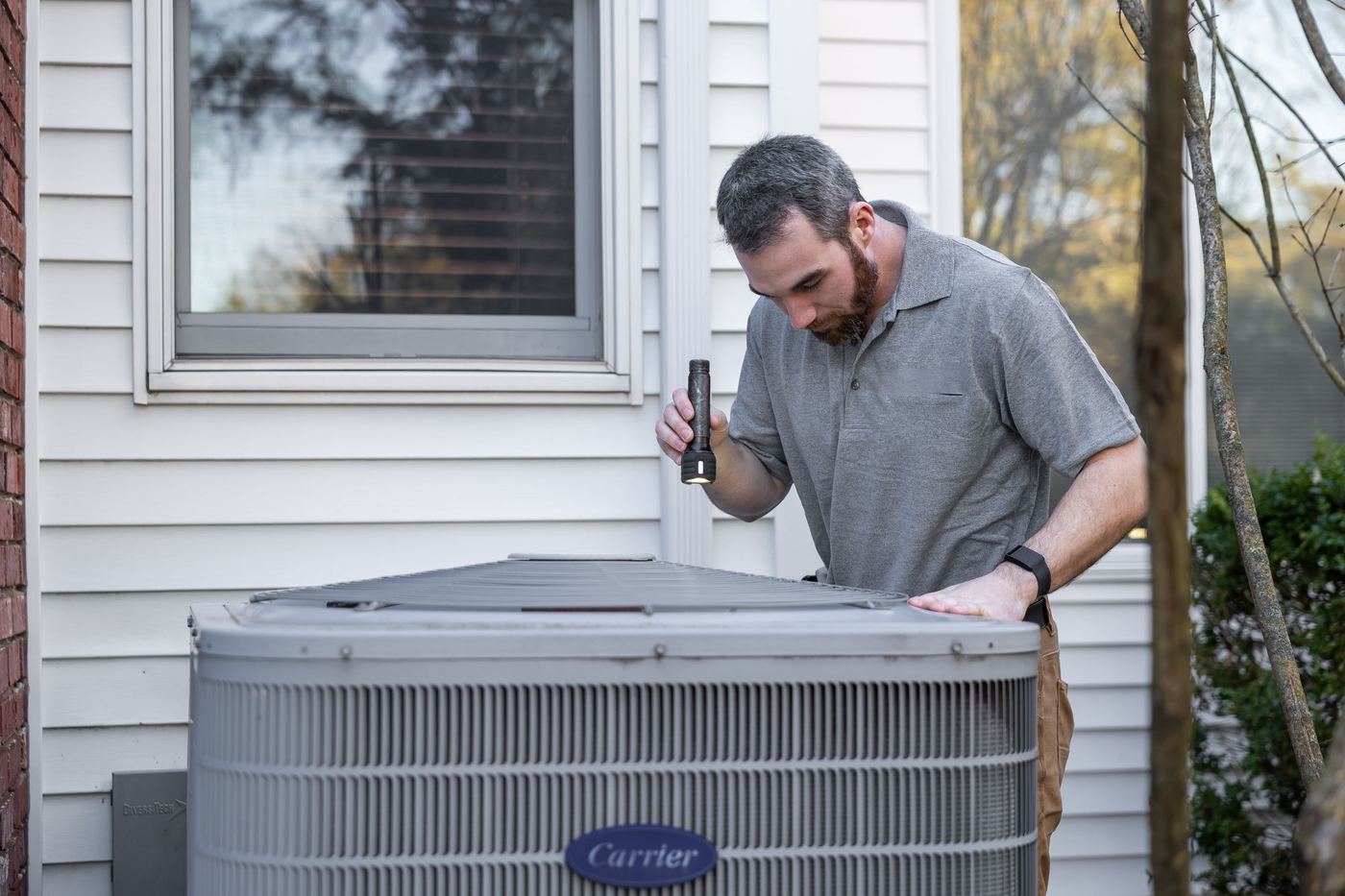 Technician checking an outdoor air conditioning unit