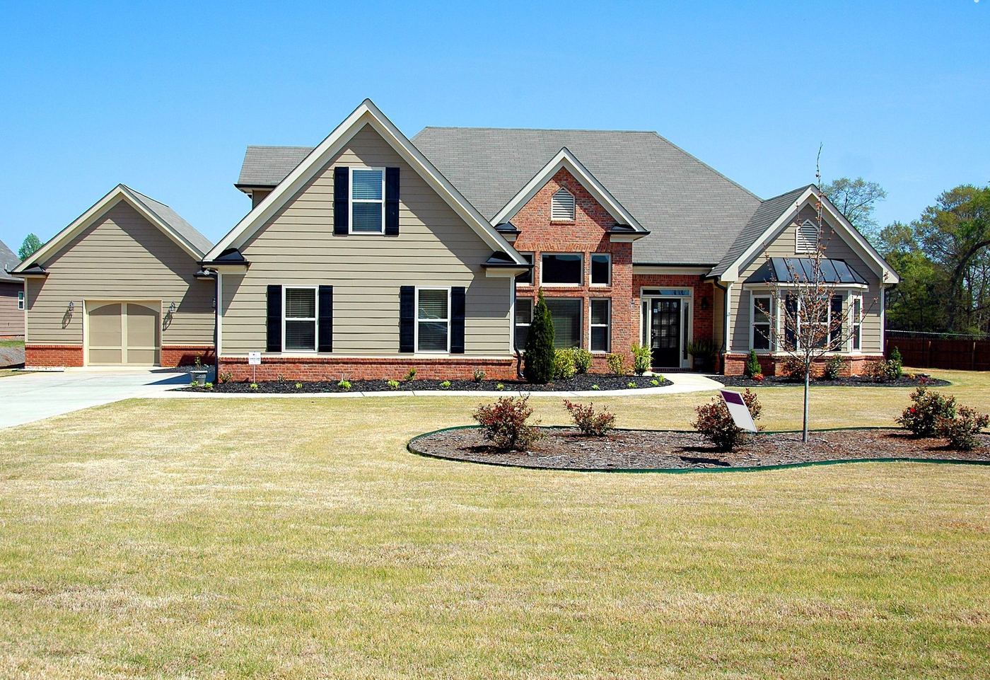 Two-story home with stone accents and a wide front lawn