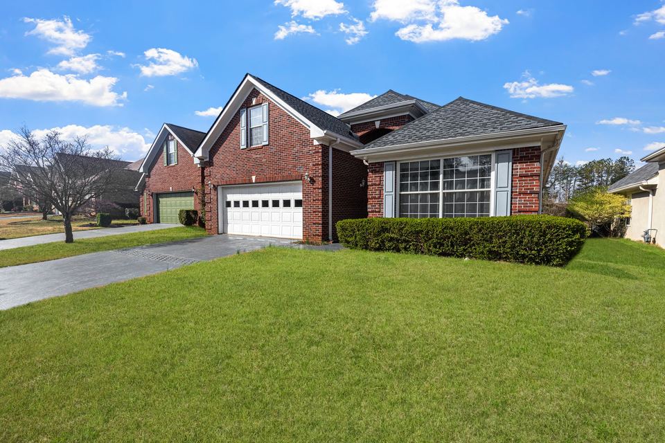 Red brick home with a green front lawn
