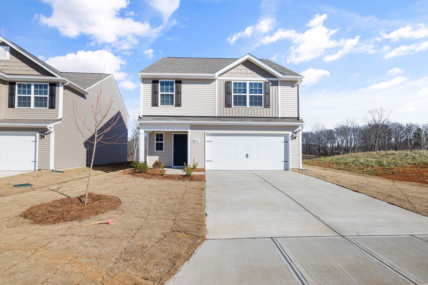 Newly built home with a driveway, ready for a radon test