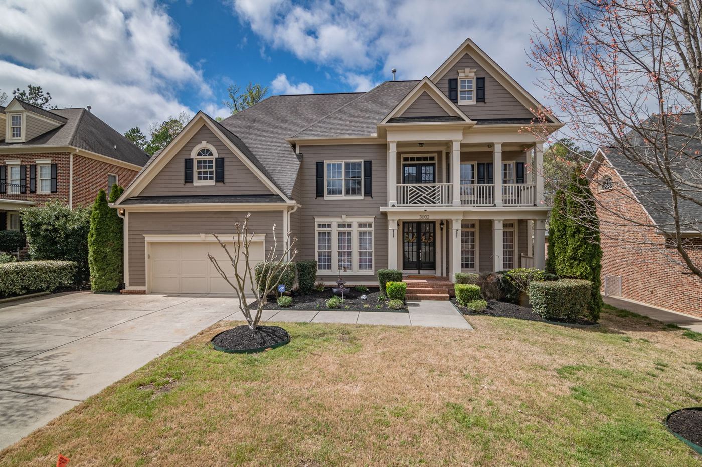 Two-story family home with a front lawn