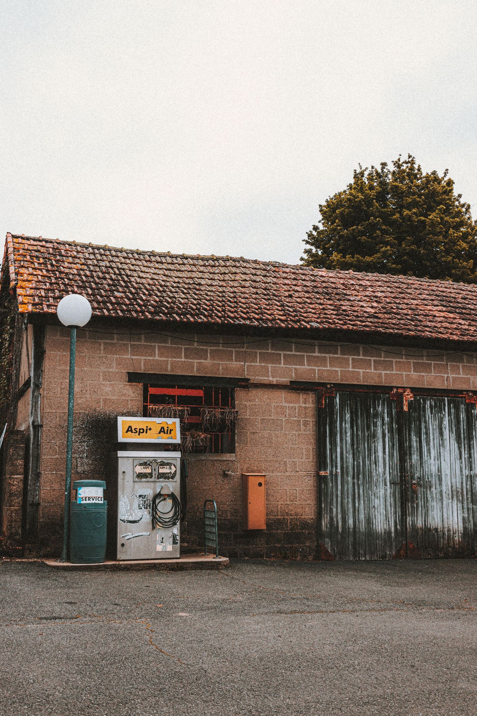 Old service station building with a fuel pump